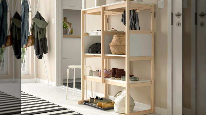 FLISAT shoe rack by entryway with shoes and other items on the shelves