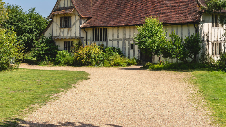 A gravel driveway in need of a crown.