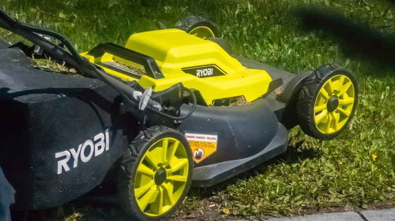 Ryobi rotary mower cutting its way through the grass