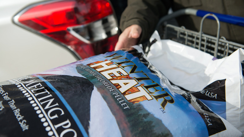 a man loading a calcium chloride ice melt product that advertising working faster than rock salt
