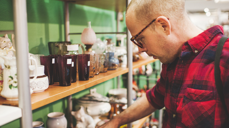 Man searching shelves of a thrift store