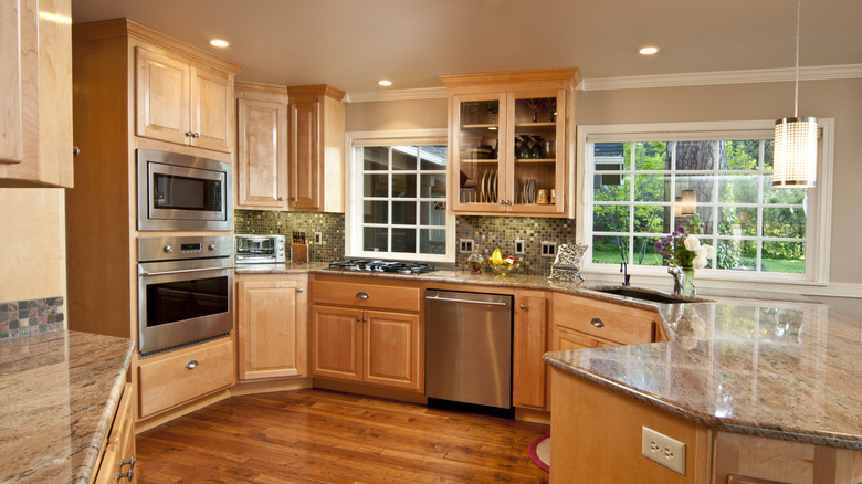 A kitchen with wood accents and glass cabinets.