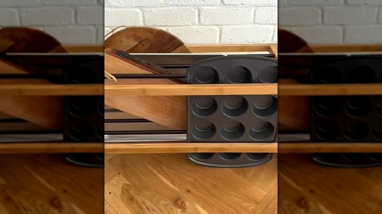 Shoe rack turned into baking pan storage solution sitting on countertop