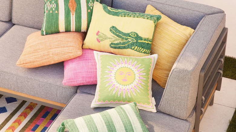 Assortment of colorful outdoor throw pillows on an outdoor sofa