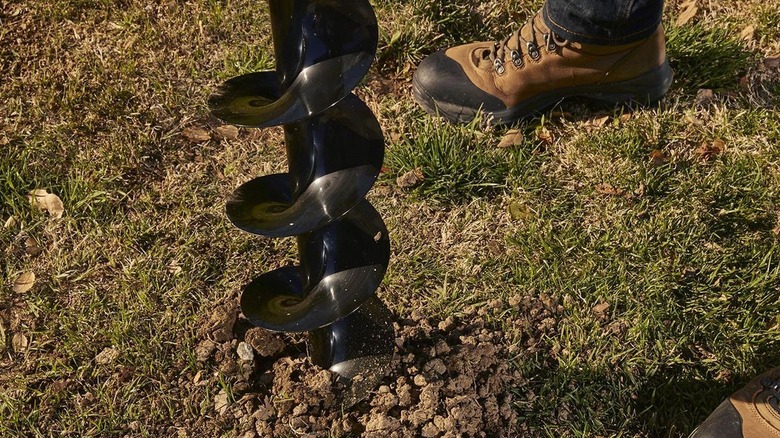 The Predator earth auger's bit biting into the ground