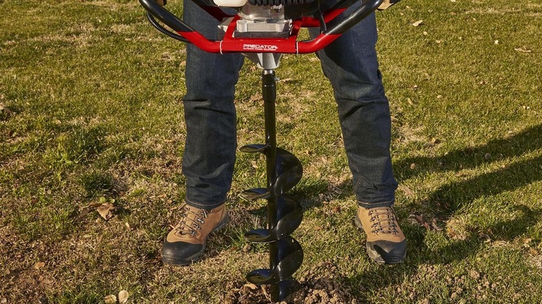 Digging a hole with the Predator earth auger