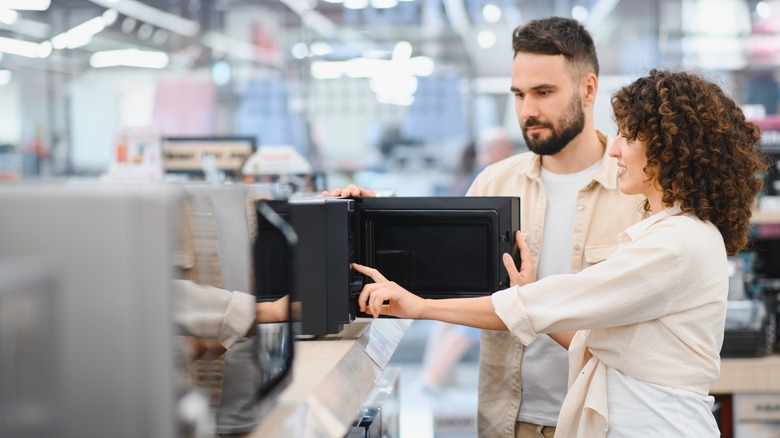 Young couple shopping for appliances