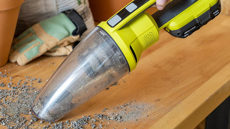 Ryobi handheld vacuum sucking up dirt