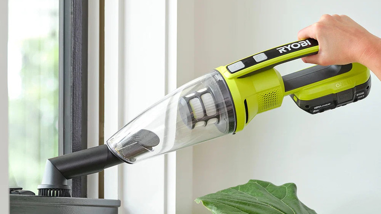 Ryobi performance handheld vacuum dusting a window frame