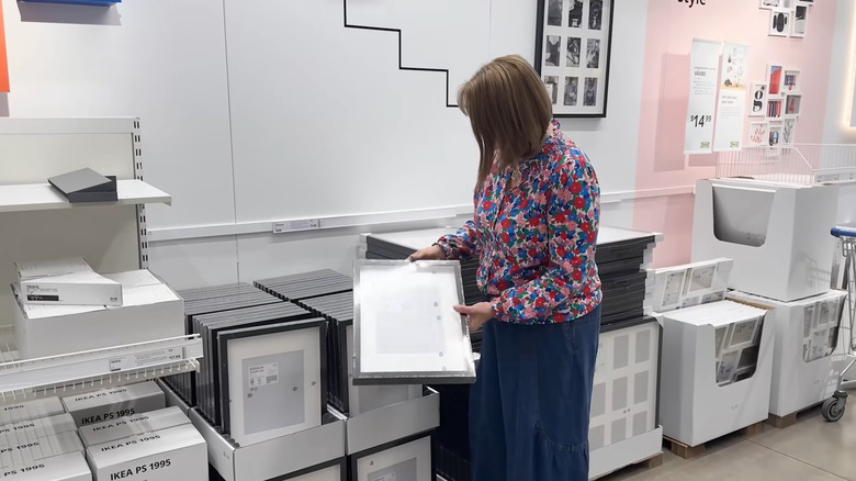 Woman shopping for photo frames at IKEA