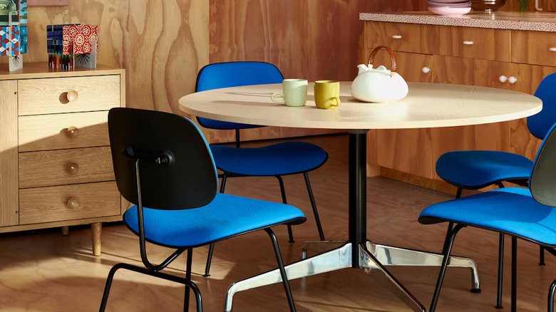 An orange-red Herman Miller Eames dining table