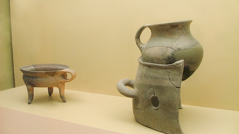 An ancient chytra resting on a brazier at the Ancient Agora Museum in Athens.