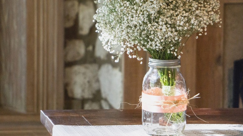 Mason jar flower vase on a kitchen table