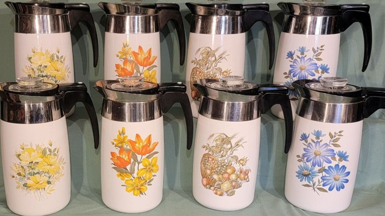 A collection of coffee pots with Corningware's Say it With Flowers patterns