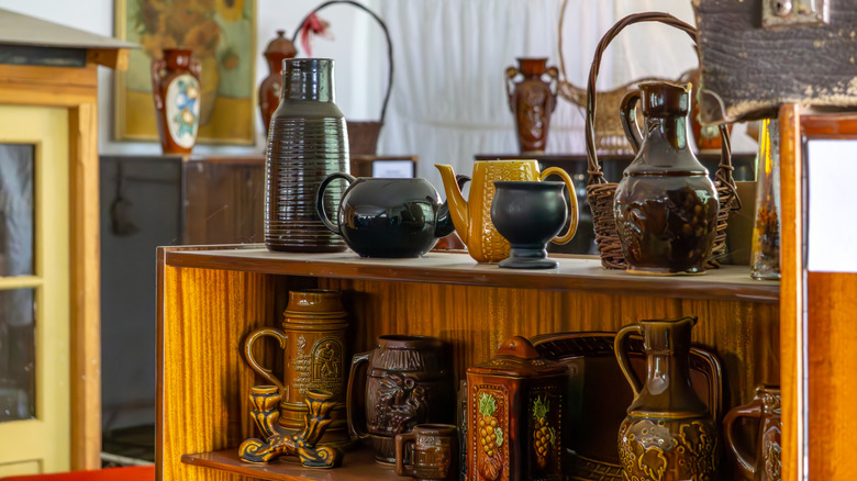 Shelves of vintage pottery at a thrift store