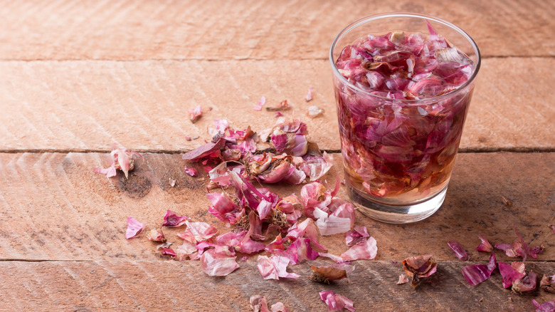 red onion peels soaking in a glass full of water