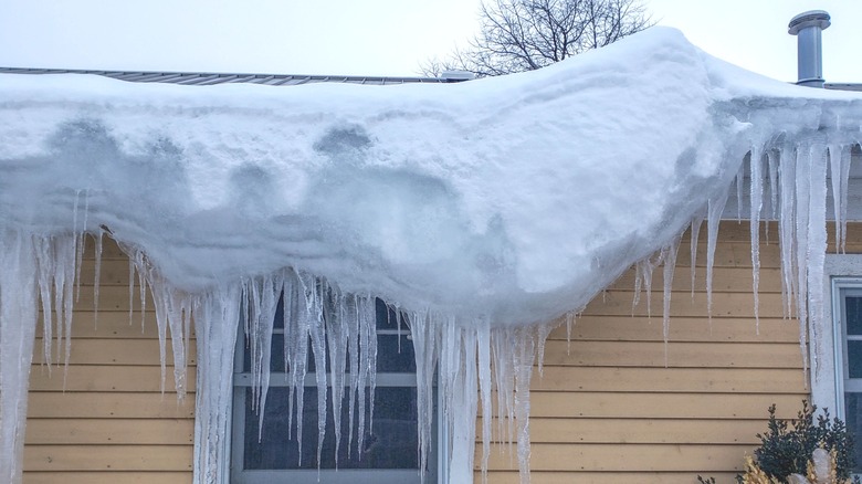 Snow hanging off of a roof