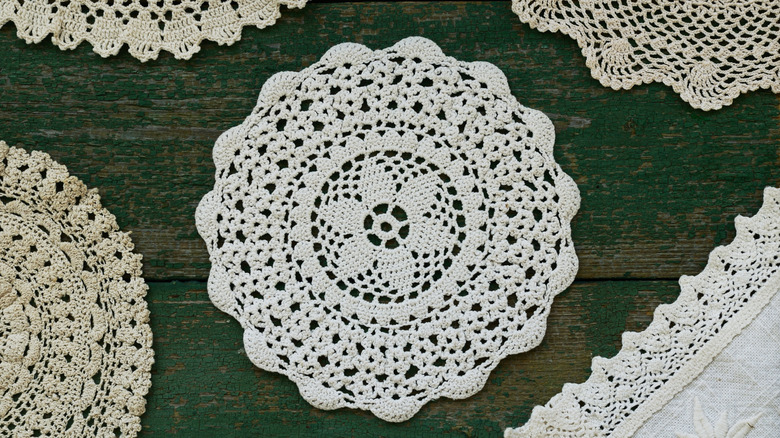 A collection of vintage doilies on a wooden table