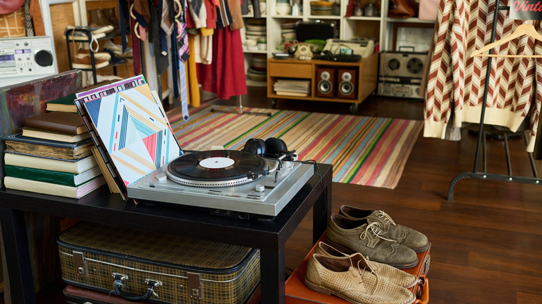 Record player and stack of books in a '70s inspired thrift store