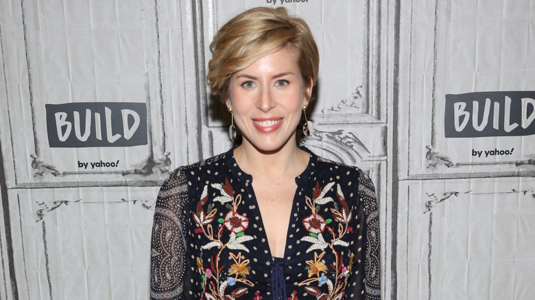 Erin Napier of HGTV's "Home Town" wearing a black embroidered top at an event