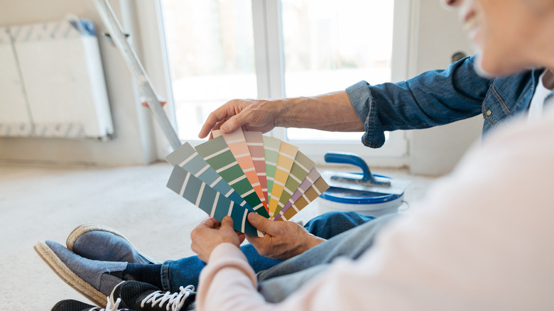 Couple looking at paint samples for their home renovation