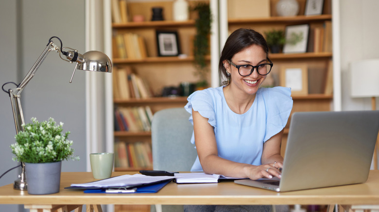 Smiling young woman in home office