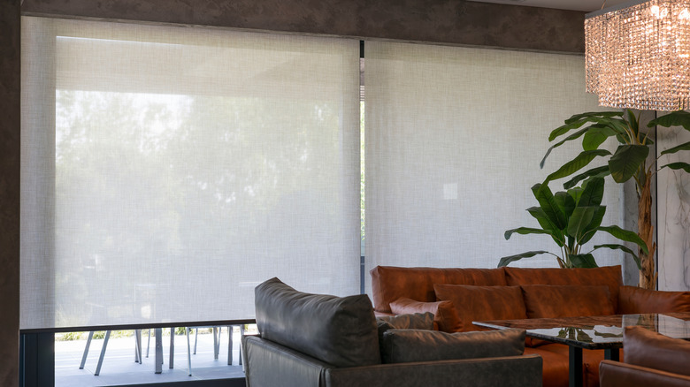 White solar shades covering a sliding glass door in a home