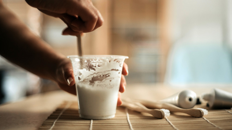 mixing vegetable oil and baking soda into a paste