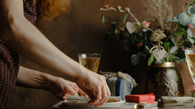 A woman prepares her dinner table