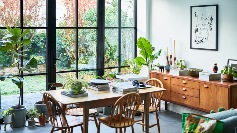 modern cozy dining room with transitional wood table and chairs, as well as a mid-century wood buffet