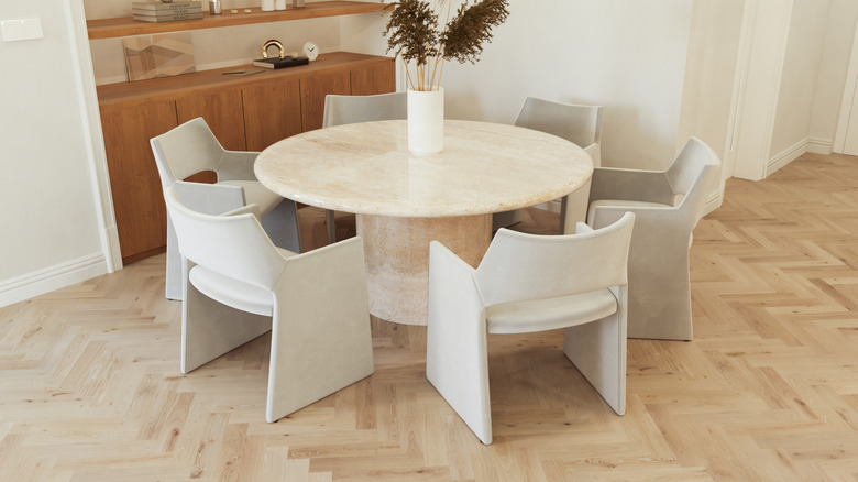 contemporary dining room with a marble table and white chairs
