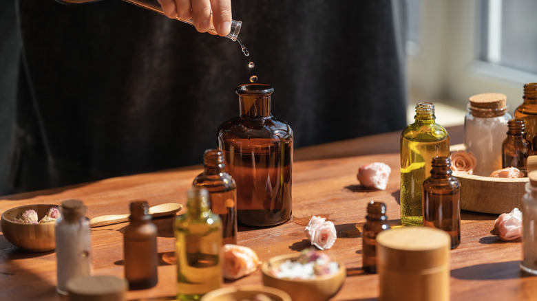 A person prepares an essential oil solution for disinfection