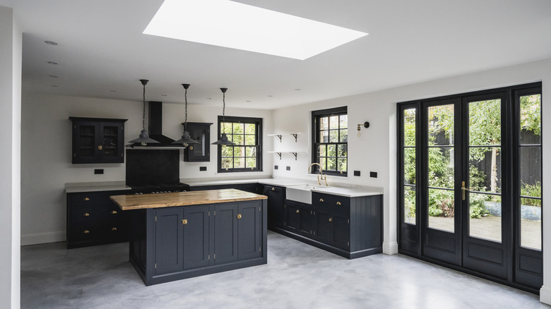 Black and white kitchen with light gray floors.
