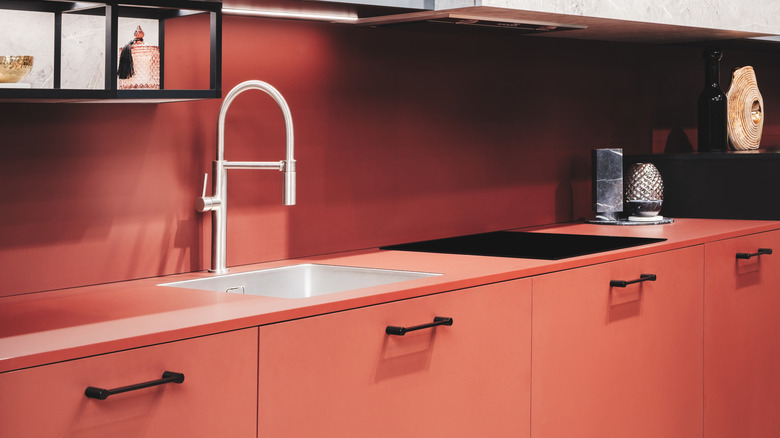 Kitchen with pink countertop and cabinets