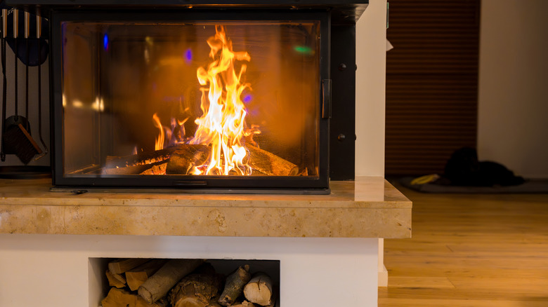 Wood-burning fireplace with log stack underneath