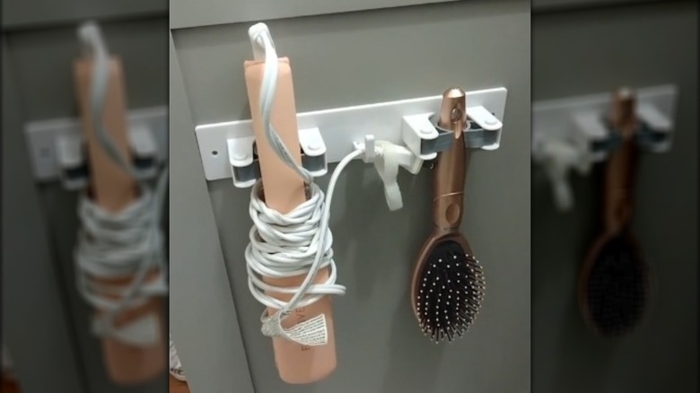 Styling tools clipped to inner cupbaord door