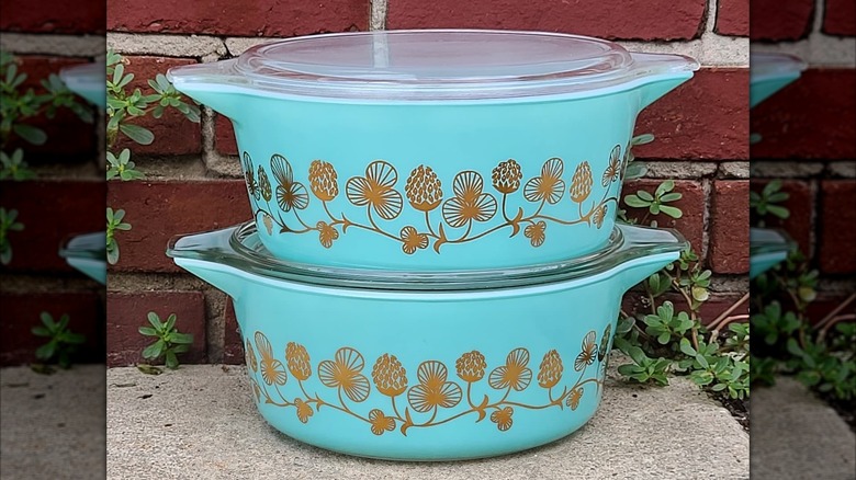 Two vintage Pyrex casseroles in the Clover Berry pattern stacked on top of each other.