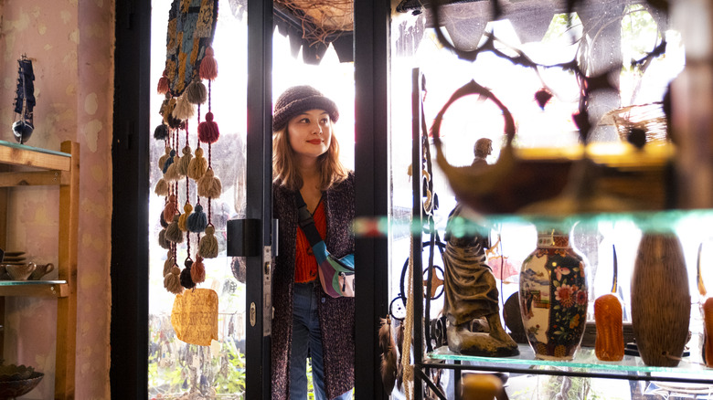 Young woman entering a thrift shop