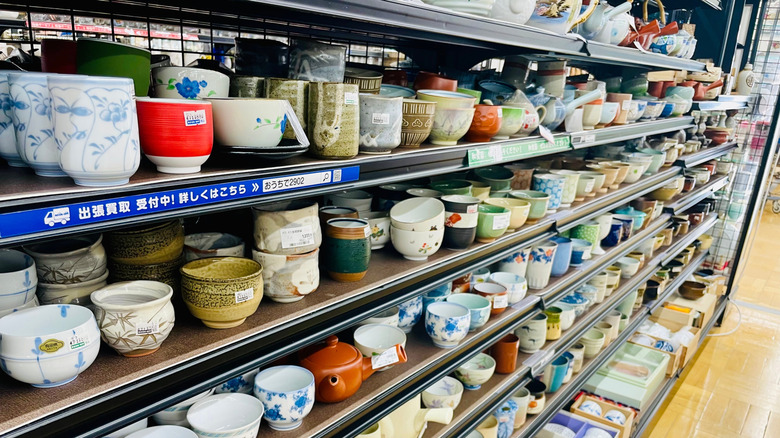 Thrift store full of vintage ceramic bowls and mugs and dinnerware