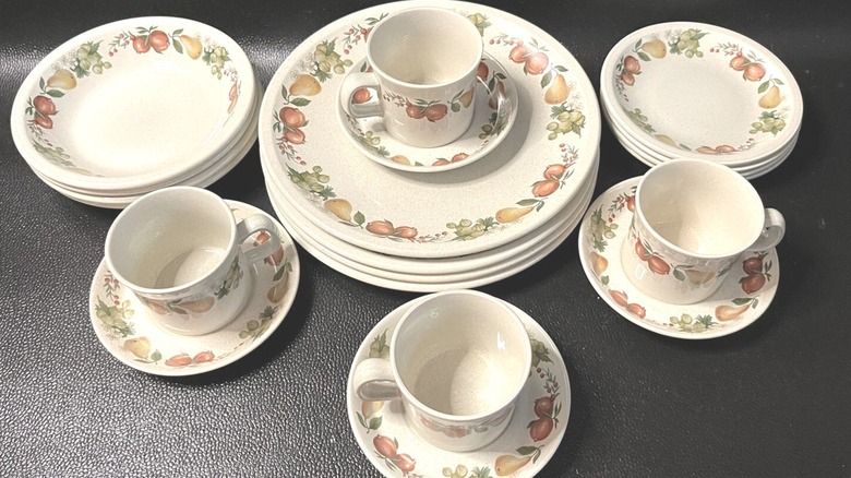 1970s vintage Wedgwood Quince pattern dinnerplate and mug set on black surface