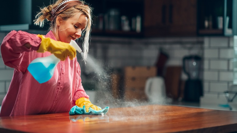 Woman cleaning kitchen countertops