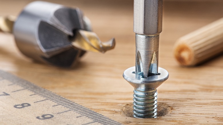 A screw driven into a pilot hole created with a countersink bit