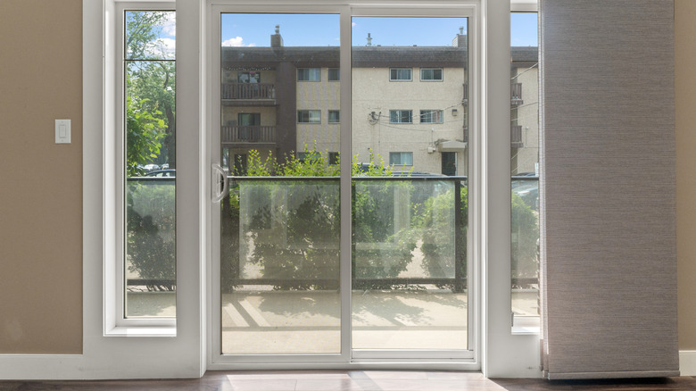 Sliding glass doors with a view of an apartment building