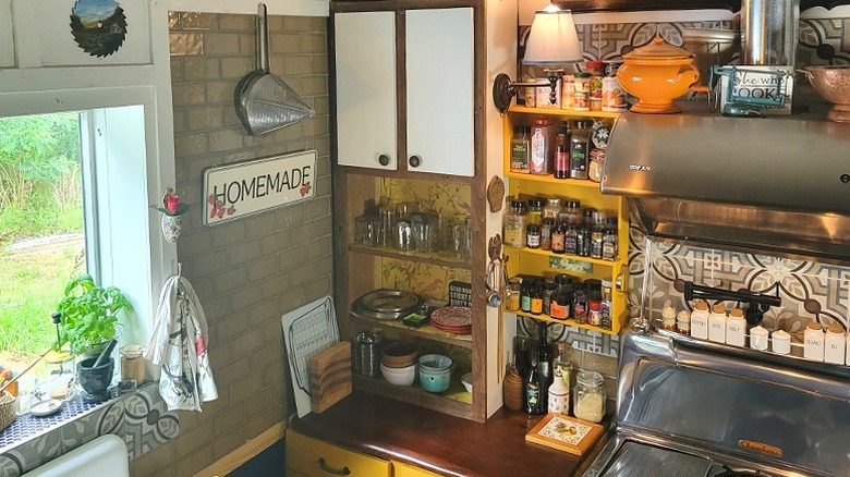 An upended thrifted bookcase as a countertop cabinet in an unfitted kitchen