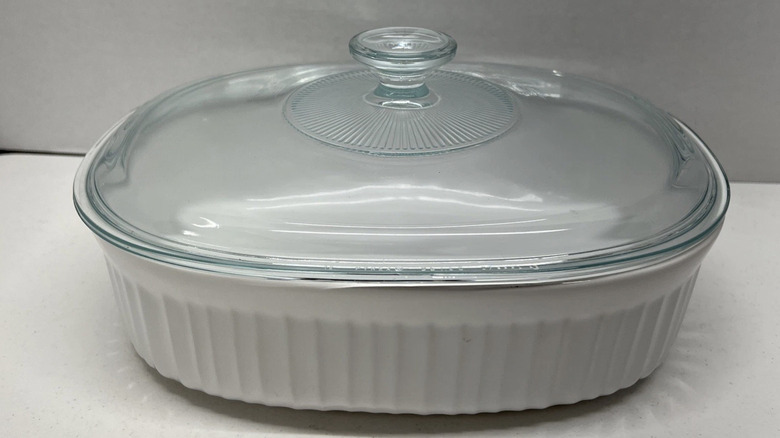 A French White CorningWare casserole dish with a lid