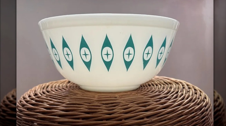 Atomic Eyes large chip bowl from chip-and-dip Pyrex set on woven stool.