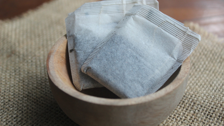 Bags of black tea in a bowl