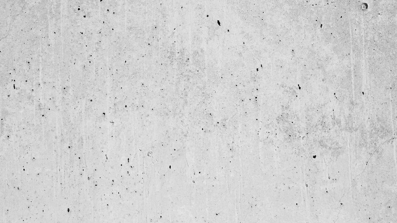 Close up of a salt finish concrete surface with colorful striations and holes in its surface