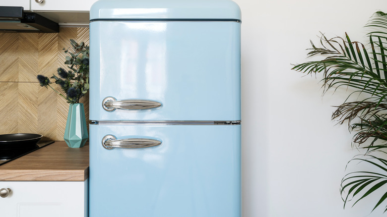 A retro light blue fridge in a kitchen