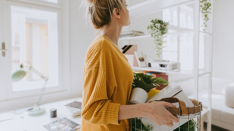 Woman carrying basket of decor to decorate home
